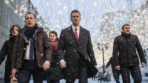 Russian opposition leader Alexei Navalny, centre, heads to attend a meeting at the Central Election commission on Monday.