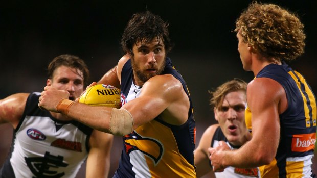 Josh Kennedy of the Eagles muscles his way past Blues players during Friday's game at Domain Stadium.