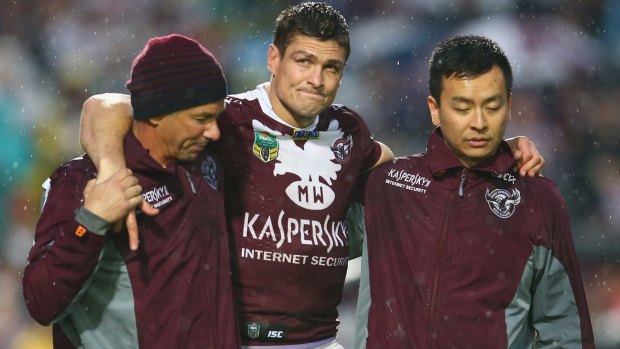Still injured: Matt Ballin leaves the field after he injured his knee playing for Manly last August.