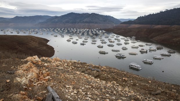 Houseboats at Bidwell Canyon Marina drop with the water level in Lake Oroville, California. 