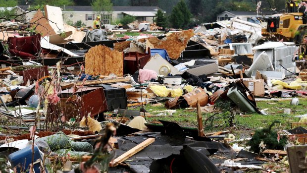 Debris from buildings and household goods scatter after a tornado hit Prairie Lake Estates.