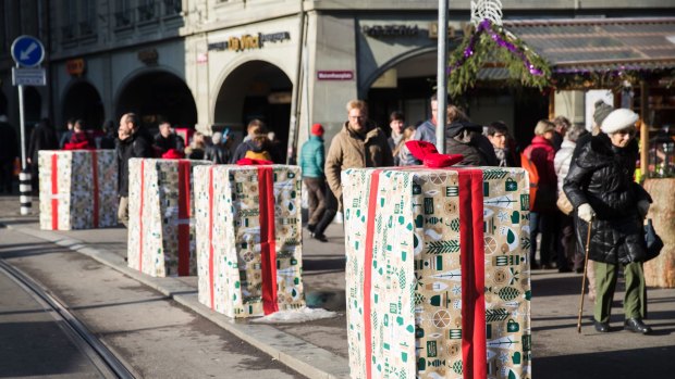 Concrete barriers wrapped in gift paper stand around the Christmas market in Bern.