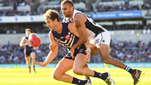 Dockers' Michael Barlow is tackled by Nathan Krakouer.