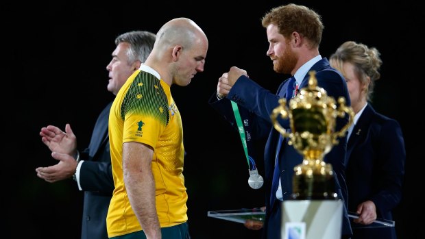 Gracious in defeat: Prince Harry presents Stephen Moore with his medal after the World Cup final.  
