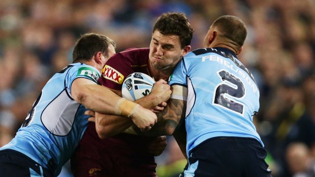 Crunch: Maroons winger Corey Oates is tackled during game one of the State Of Origin series between the NSW Blues and Queensland at ANZ Stadium.