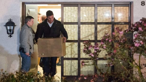 Investigation under way: Police carry a computer, a box and bags out of the residence of the parents of Andreas Lubitz, co-pilot on Germanwings flight 4U9525, in Montabaur, Germany.