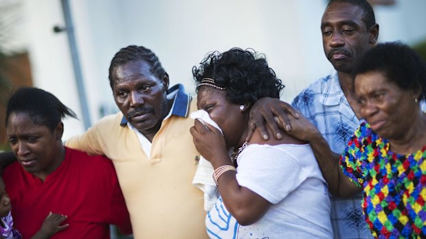 Gary and Aurelia Washington, centre left and right, the son and granddaughter of Ethel Lance, who died in the shooting.