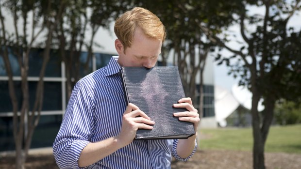 WDBJ7 news anchor Chris Hurst holds a photo album by fellow reporter and girlfriend Alison Parker.