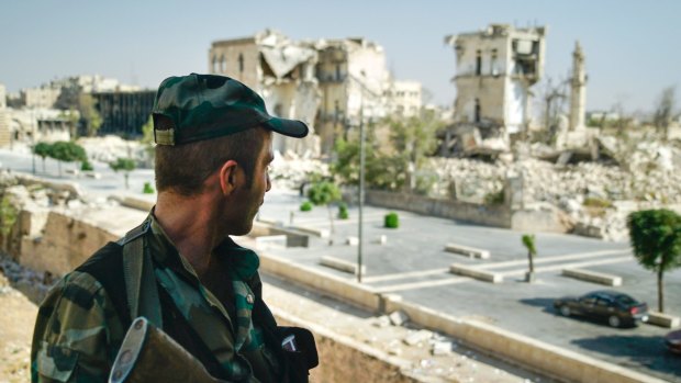 A Syrian soldier guards streets in ruined Aleppo, Syria, this week. 