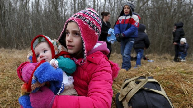 Kosovar children wait for their parents on the Hungarian-Serbian border  in February.