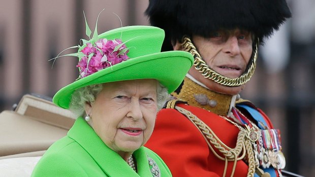 The Queen and Prince Philip ride in a carriage during the Trooping The Colour parade at Buckingham Palace in London. 