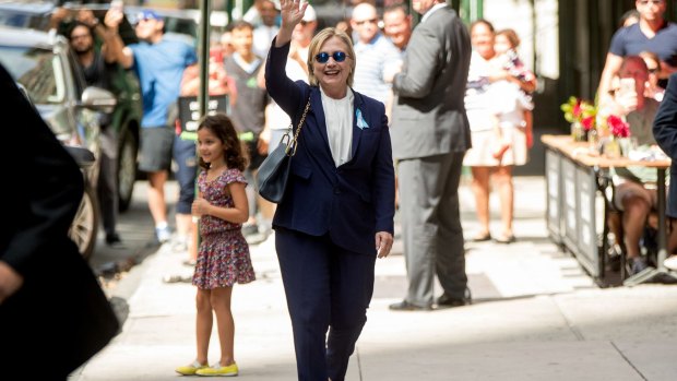 Hillary Clinton waves after leaving her daughter's apartment on Sunday.