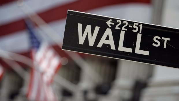 Wall Street investors are sitting tight ahead of moves by the Fed and developments in Greece.