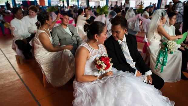 Filipino gay couples exchange "Rite of Holy Union" vows during a mass "wedding rites" in June in Manila. A small Christian ecumenical group officiated the weddings, but the unions are not officially recognised under law.