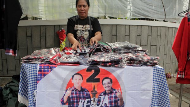 An Ahok shirt seller waits for customers in the Jakarta suburb of Menteng.  