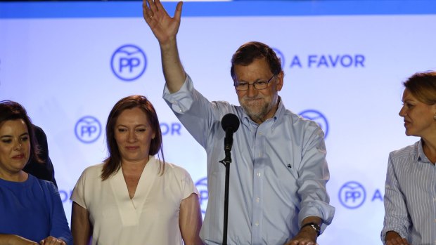 Mariano Rajoy waves to his supporters after the result, which improved the position of his People's Party after an inconclusive election last year.