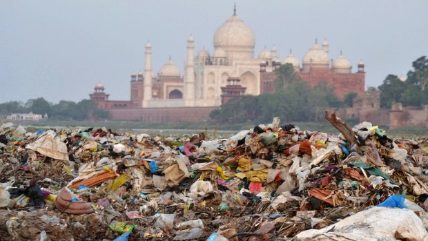 Garbage covers the area by the Yamuna river near the Taj Mahal in Agra, India. The shining white monument to love is turning a little green and yellow because of air pollution and swarms of insects. 