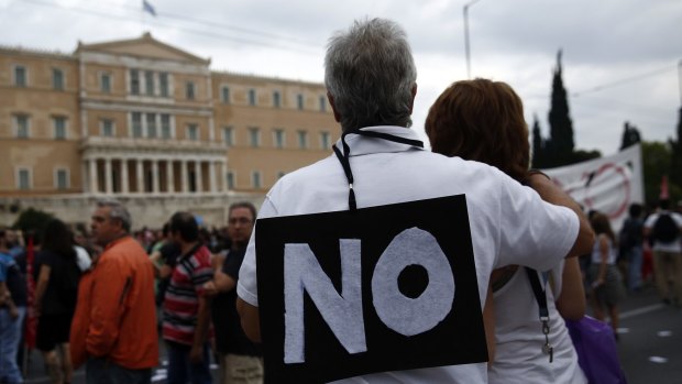 A protester wears a 'No' sign during an anti-European Union demonstration outside the Greek parliament at Syntagma square in Athens on June 28.