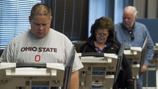 Early voters cast their ballots on electronic voting machines  in Lancaster, Ohio, on Saturday.