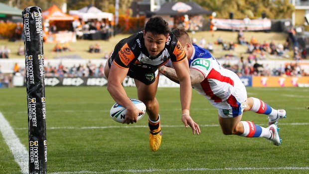David Nofoaluma of the Tigers dives over to score the opening try.