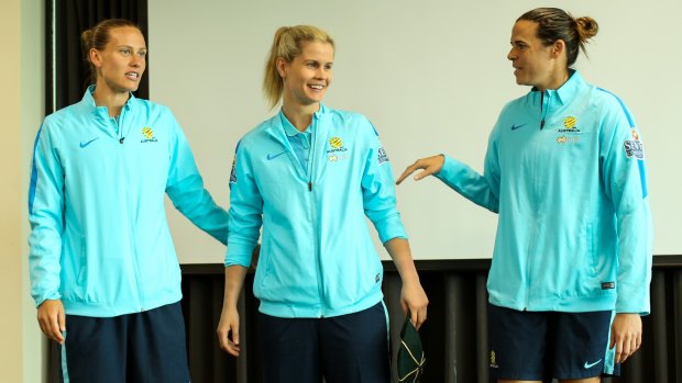 Emily Van Egmond (L) and Lydia Williams (R) present a shy Eliza Campbell with her Matildas cap after she made her debut on Wednesday. 