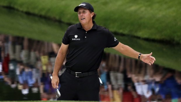 Phil Mickelson reacts after hitting onto the 16th green during the fourth round of the Masters.