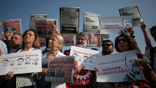 Edgogan's crackdown has been broad: Demonstrators hold copies of the Cumhuriyet newspaper, as they protest against a trial of journalists and staff from the newspaper