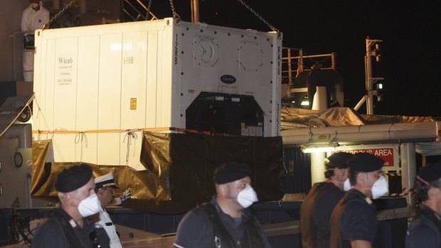 A refrigerated container with the bodies of dead migrant is unloaded from Swedish ship Poseidon at the Palermo harbour on Thursday.