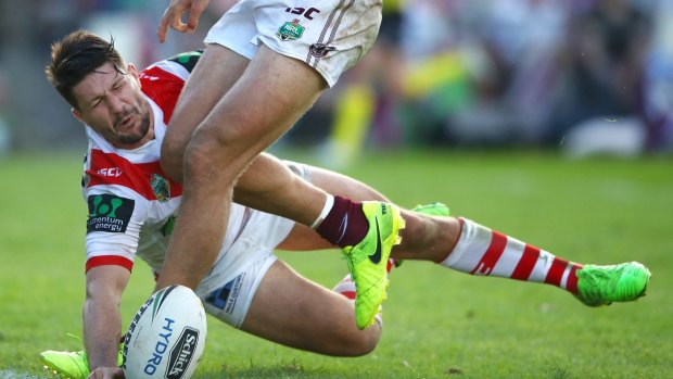 Involved in early controversy: Gareth Widdop pounces to score one of his two tries.
