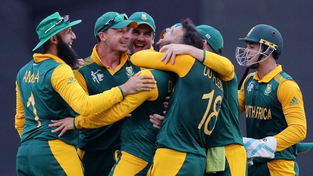 Three and easy: South Africa celebrate JP Duminy's hat-trick.