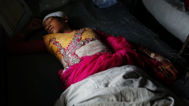 An injured Rohingya girl Jubayra, 10, receives treatment after crossing over from Myanmar into Bangladesh on Friday.