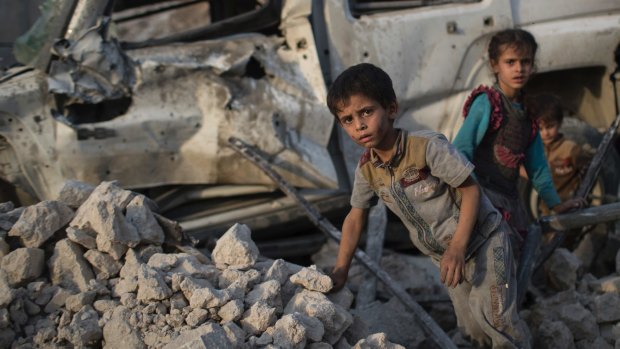 Iraqi children flee through the rubble as Iraqi forces continue their advance against Islamic State militants in the Old City of Mosul.