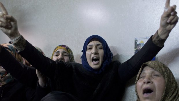 Palestinian women view the body of Ramzi al-Qasrawi, 21, during his funeral in the West Bank city of Hebron in March, 2016.