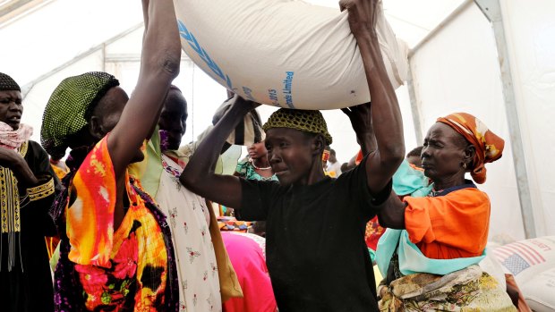 Familiar sight: Queues form at the United Nations food distribution centre at Mingkaman, South Sudan.