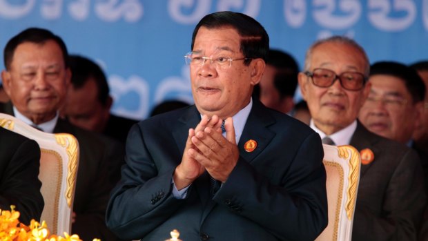 Cambodian Prime Minister Hun Sen, centre, applauds during the 66th anniversary of the Cambodian People's Party in June.