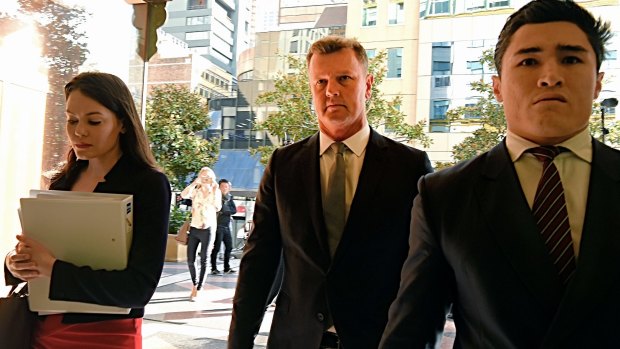 Anthony Bell, centre, approaches Downing Centre courts with his lawyers on Monday.