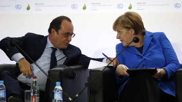 French President Francois Hollande and German Chancellor Angela Merkel at the UN Climate Change Conference in Le Bourget, outside Paris, on Monday.