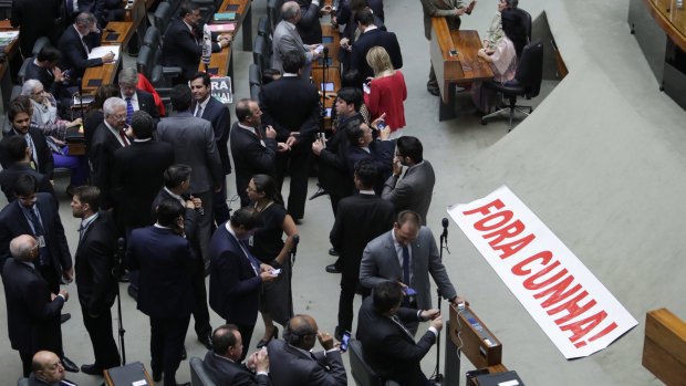 A banner that reads in Portuguese "Cunha Out!" is placed on the floor of the Chamber of Deputies during Eduardo Cunha's trial. 