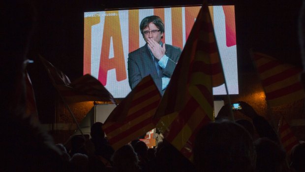 Ousted Catalan president Carles Puigdemont sends a kiss to his supporters via video link from Brussels on Tuesday.