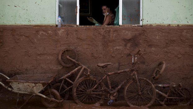 A man works on the cleaning of a house flooded with mud in Barra Longa, Minas Gerais, two days after the accident.