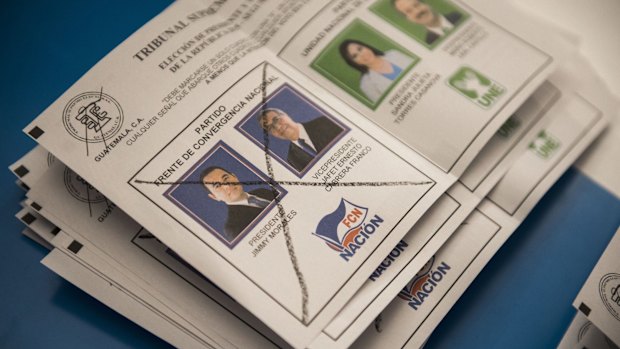 A ballot marked for Jimmy Morales, the National Front of Convergence party presidential candidate, is counted by electoral workers at a polling station in Guatemala City on Sunday.