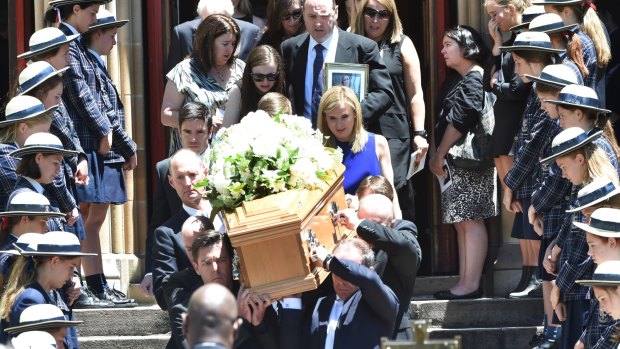 Georgina Bartter's family walk behind her casket at St Mary's, North Sydney.