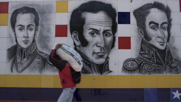 A pedestrian walks across the Simon Bolivar Bridge from Colombia into Venezuela The border has been shut and reopened in response to economic woes.