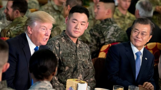 US President Donald Trump and South Korean President Moon Jae-in, right, have lunch with US and South Korean troops at Camp Humphreys in Pyeongtaek, South Korea on Tuesday.