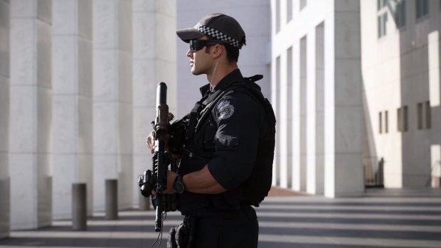 On patrol: An AFP officer armed with an SR-16 stands guard at the front of Parliament House in Canberra in October. 