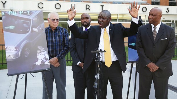 Attorney Benjamin Crump, centre, one of the attorneys for Crutcher's family, says that Terence Crutcher's hands were up contrary to police reports.