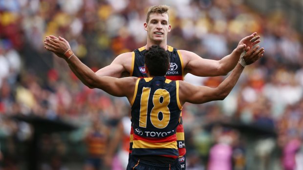 Fast forwards: Josh Jenkins and Eddie Betts celebrate a Crows goal.