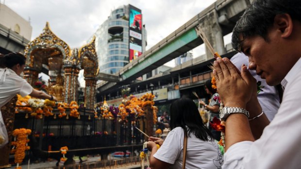 People pray at the re-opened Erawan shrine in Bangkok, Thailand, on Wednesday.