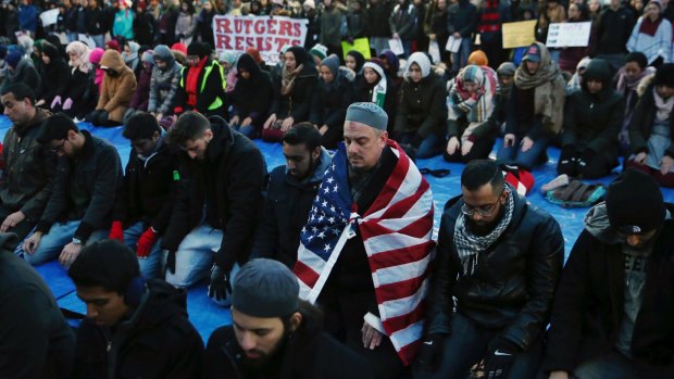 Rutgers University students and supporters gather for Muslim Prayers during a rally to express discontent with President Donald Trump's executive order.