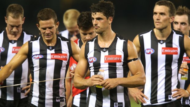 A crestfallen Magpies team after round one in 2014, following a 70-point mauling by Fremantle.